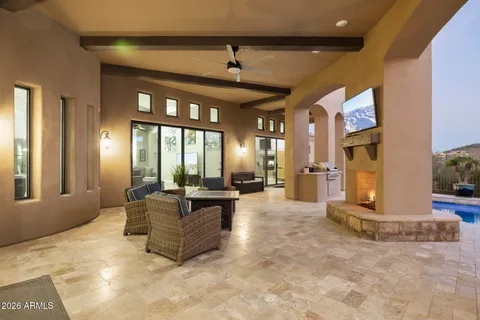 a view of a house with swimming pool and sitting area