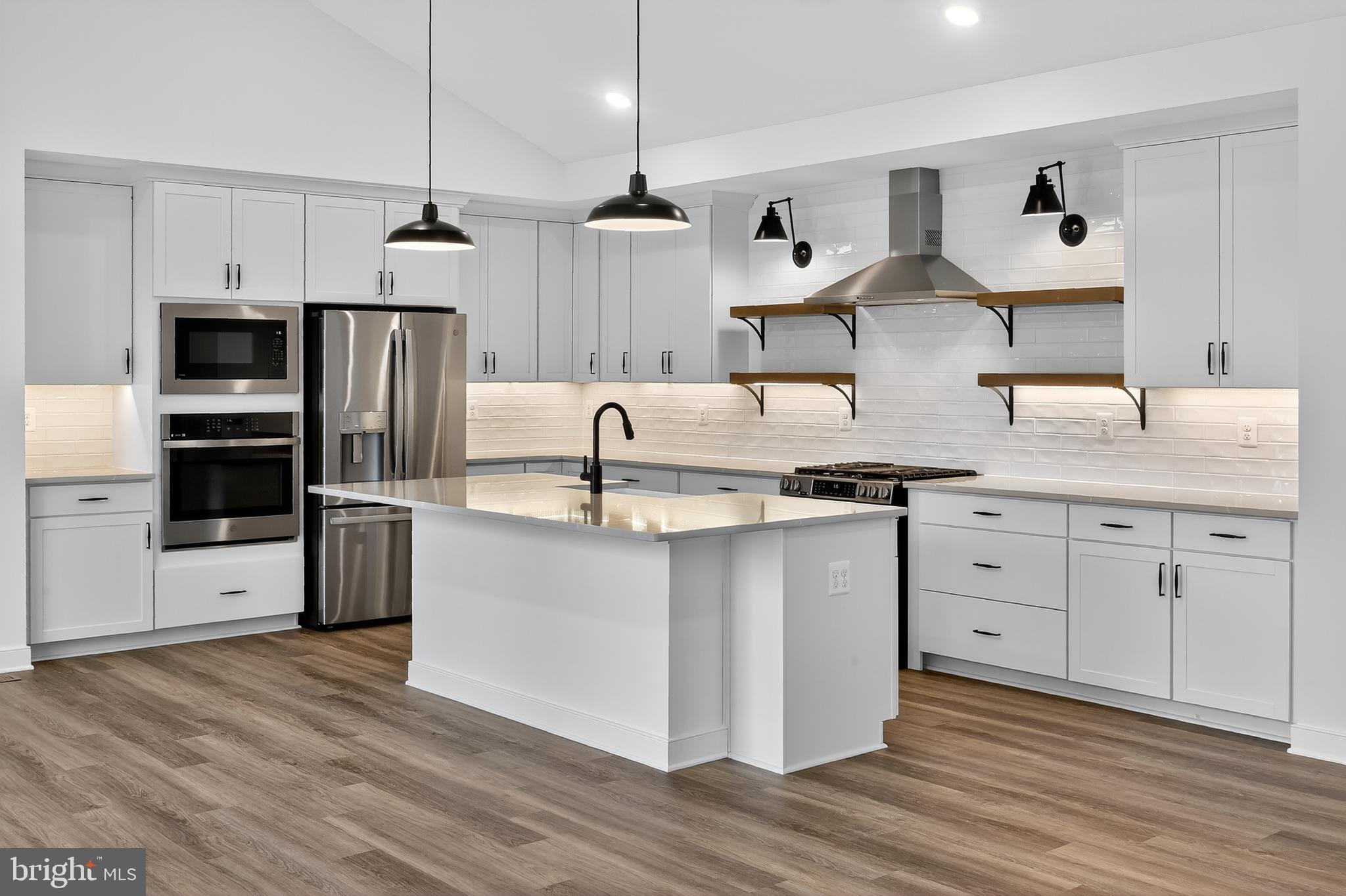 264 North Rdg Brk Drive Felton, DE 19943 - Photo 3 of 20 a kitchen with stainless steel appliances granite countertop a sink a stove and a refrigerator