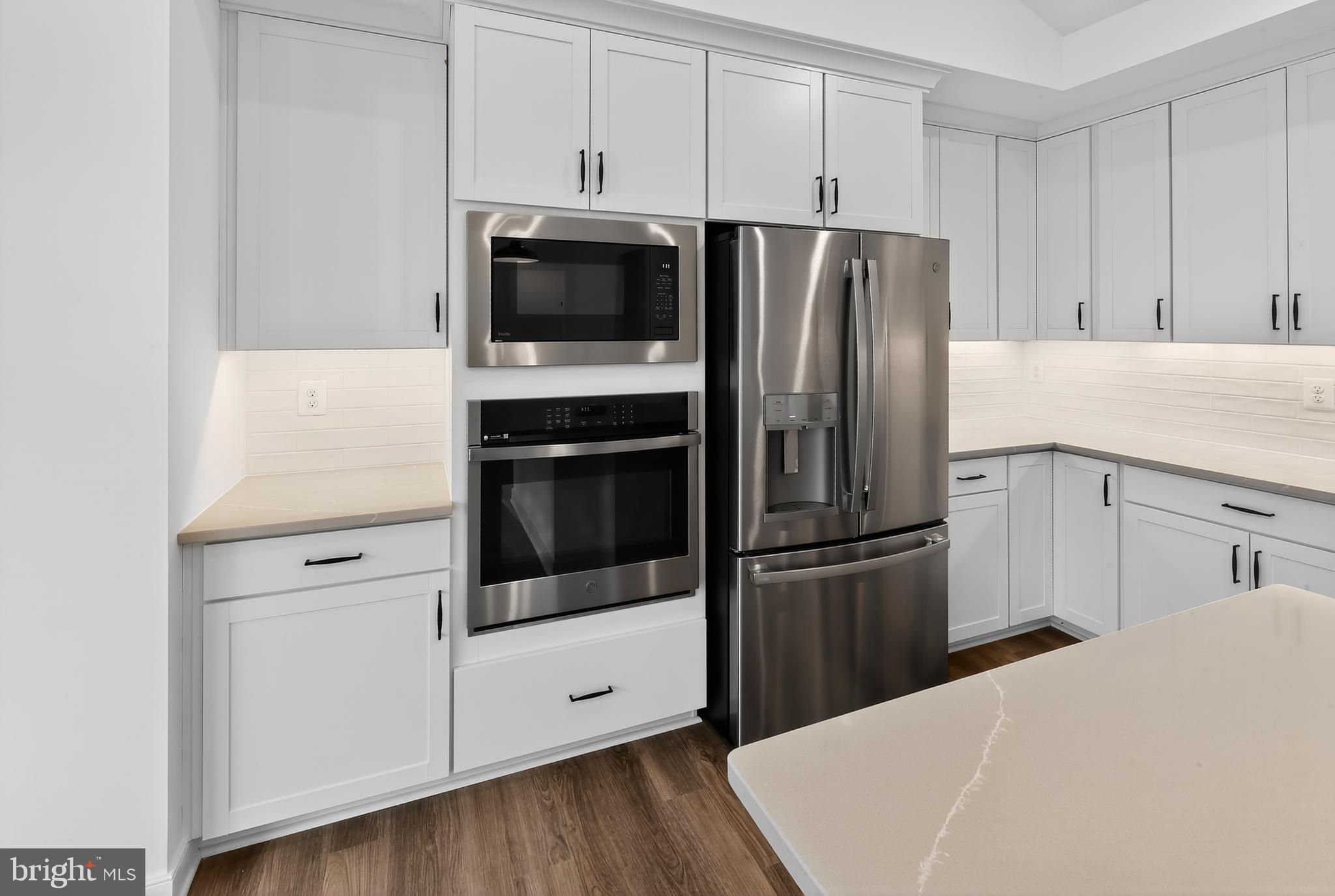 264 North Rdg Brk Drive Felton, DE 19943 - Photo 4 of 20 a kitchen with a refrigerator stainless steel appliances wooden floor and cabinets