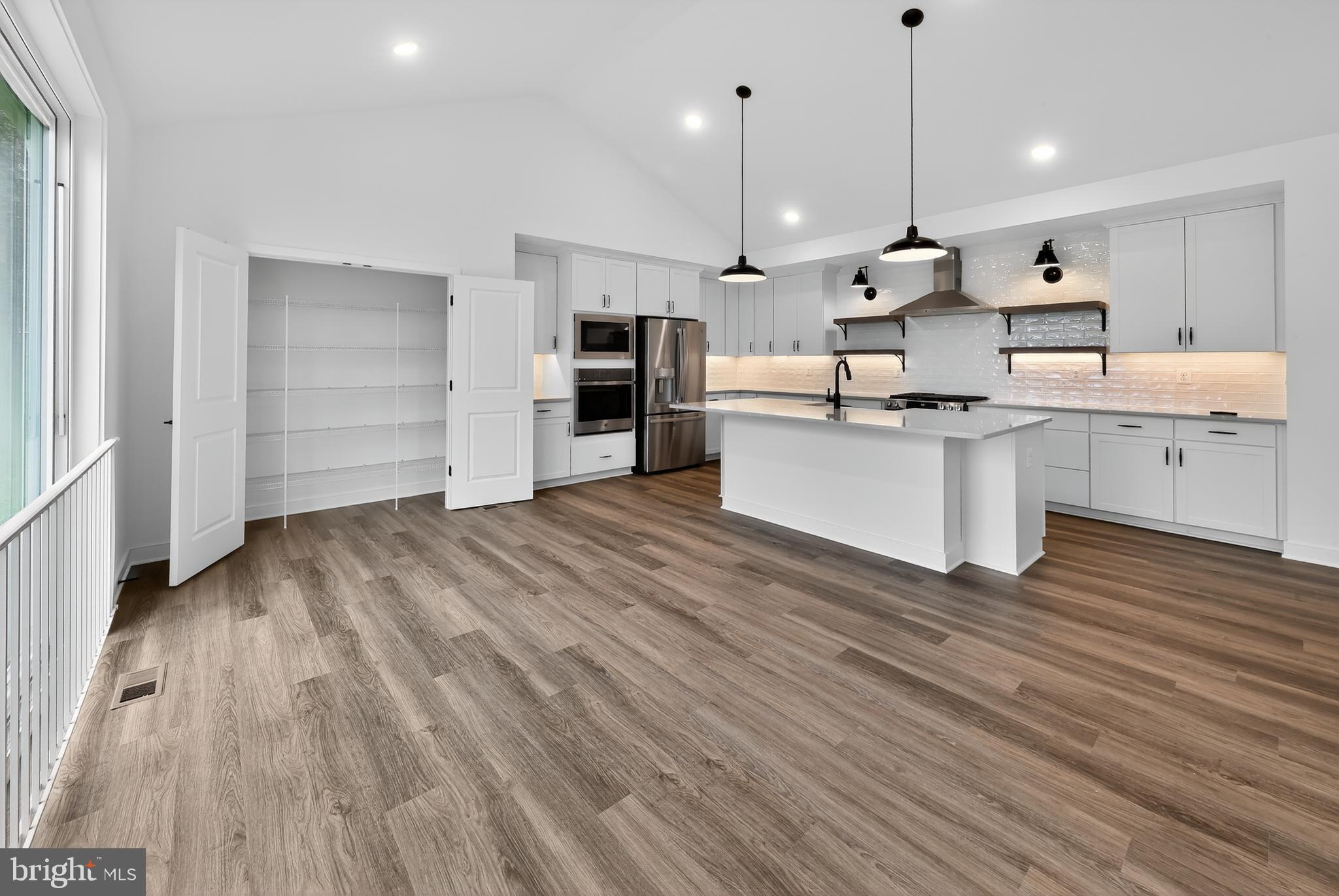 264 North Rdg Brk Drive Felton, DE 19943 - Photo 6 of 20 a large kitchen with a wooden floor stainless steel appliances and cabinets