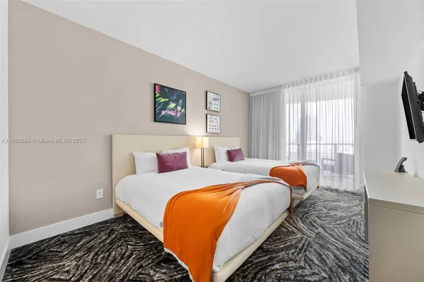 a bedroom with bed and a window