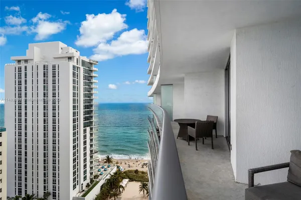 a view of a balcony with furniture