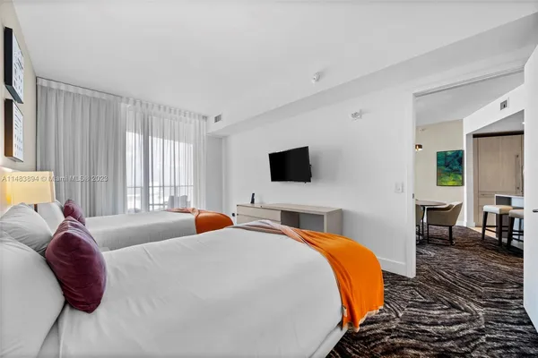 a bed room with a bed and a television