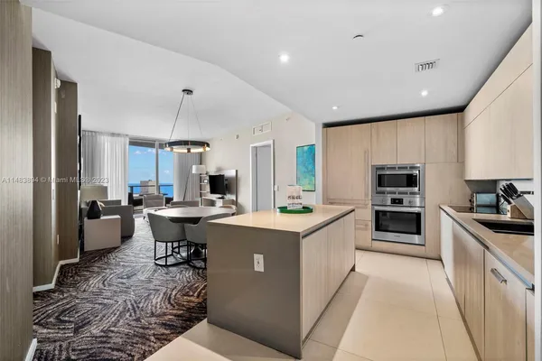 a kitchen with a sink stove cabinets and refrigerator