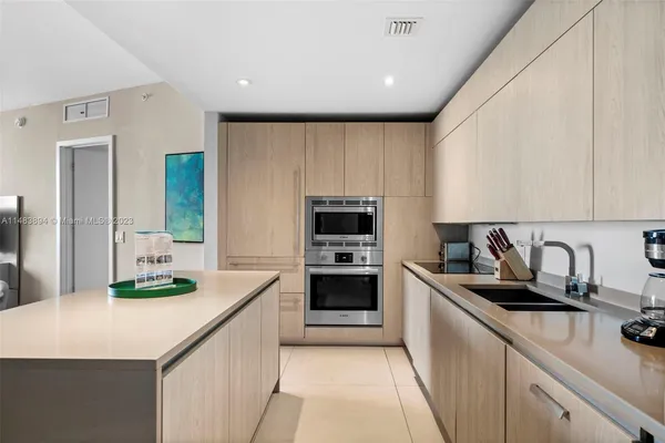 a kitchen with a sink stove and cabinets