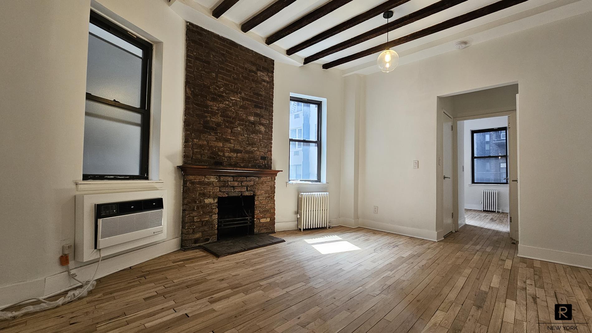 46 West 65th Street, Unit 3D Manhattan, NY 10023 - Photo 1 of 6 a view of a livingroom with a fireplace wooden floor and staircase