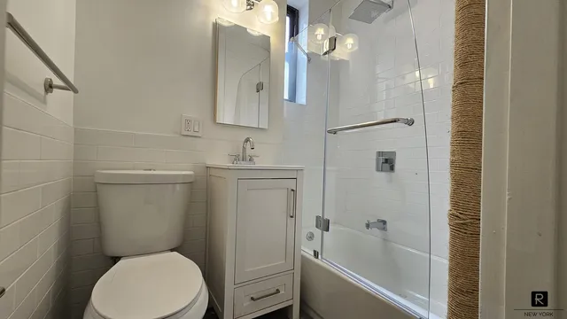 a bathroom with a toilet sink and shower