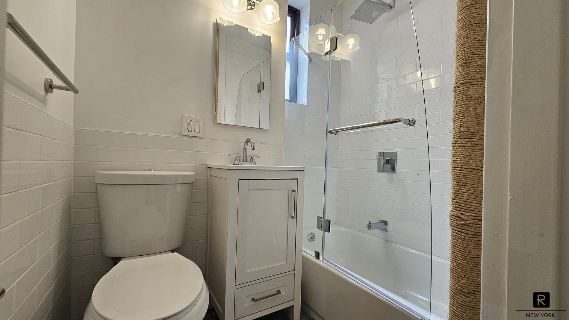 46 West 65th Street, Unit 3D Manhattan, NY 10023 - Photo 4 of 6 a bathroom with a toilet sink and shower