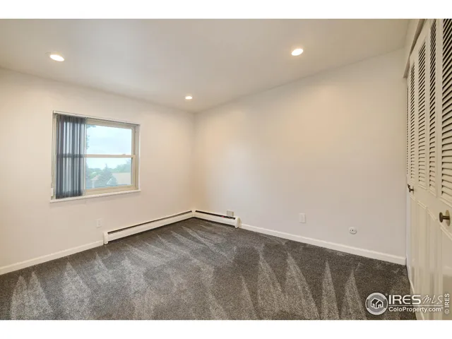 a view of an empty room with windows