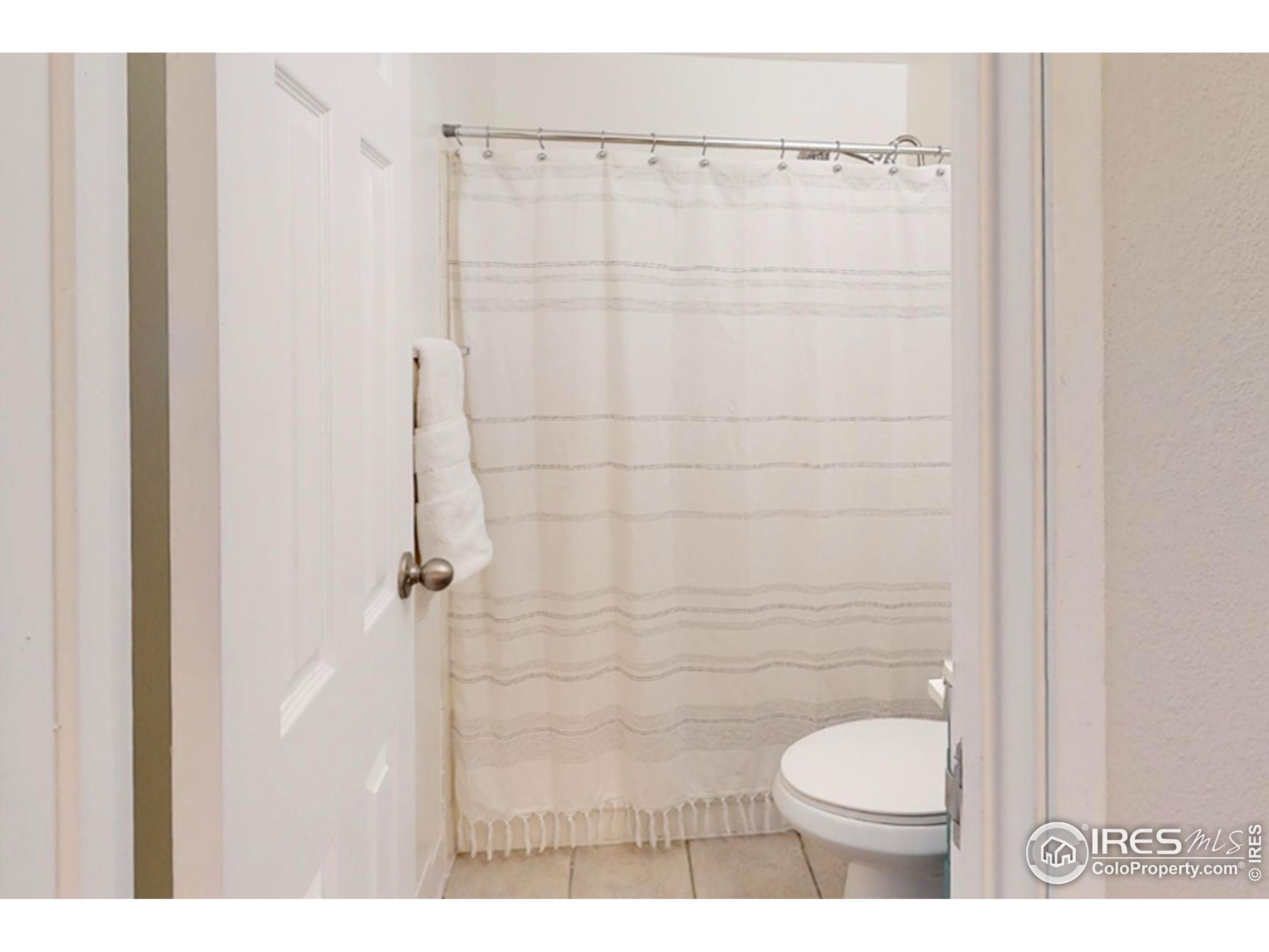 3240 Iris Avenue, Unit 201 Boulder, CO 80301 - Photo 21 of 27 a bathroom with a toilet and a shower curtain