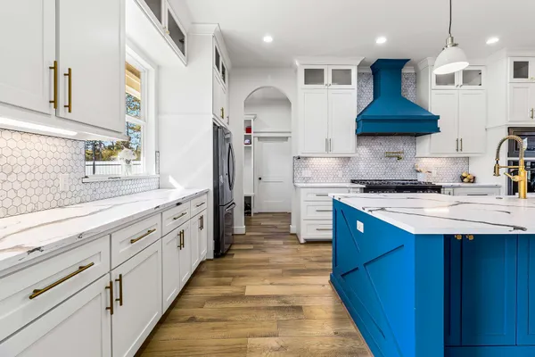 a kitchen with stainless steel appliances granite countertop a sink and a stove