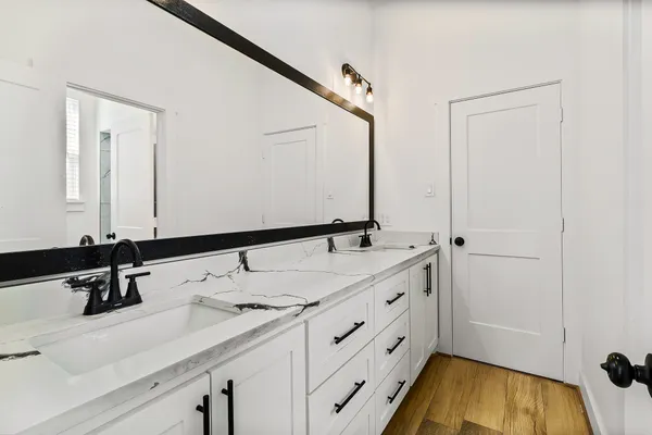 a bathroom with a double vanity sink and mirror