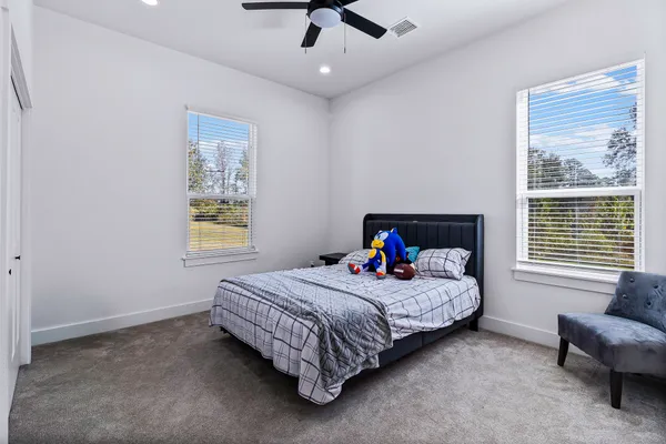 a bedroom with a bed couch and window