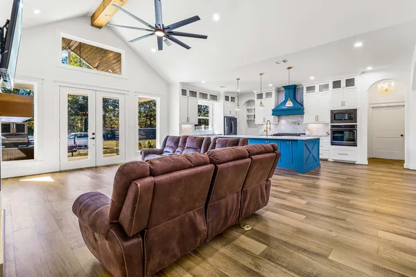 a living room with kitchen island furniture and a wooden floor