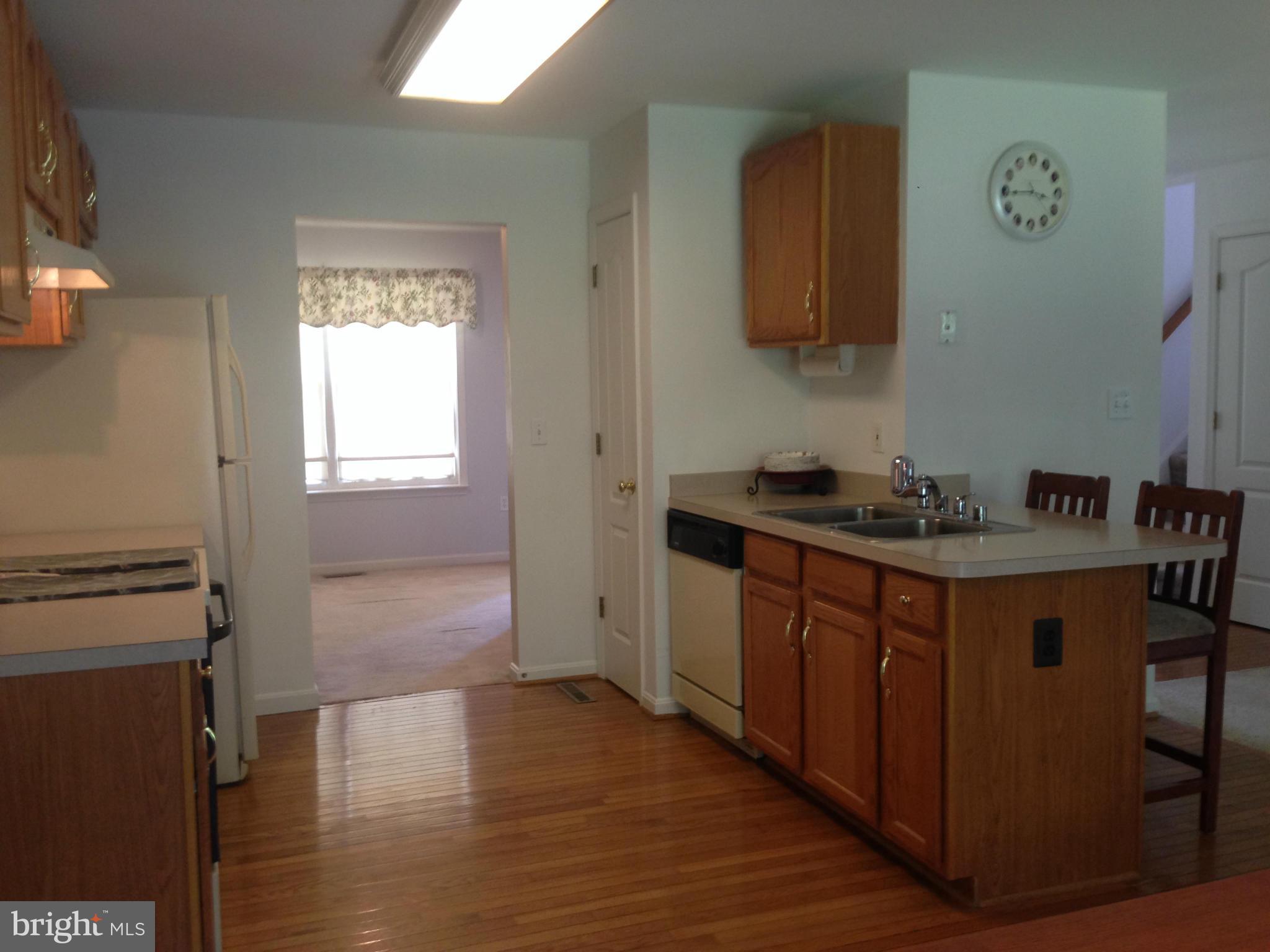 1801 Lottie Fowler Road Prince Frederick, MD 20678 - Photo 21 of 21 a kitchen with stainless steel appliances granite countertop a stove a sink and a refrigerator