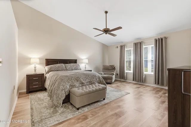 a bedroom with a large bed and a chandelier