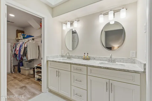 a bathroom with a double vanity sink and a mirror