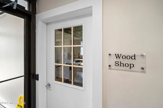 a front view of a house with a yard and potted plants