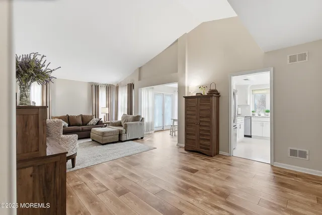 a living room with furniture and a wooden floor