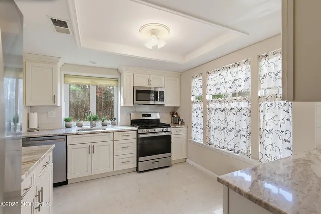 a kitchen with stainless steel appliances granite countertop a stove and a sink