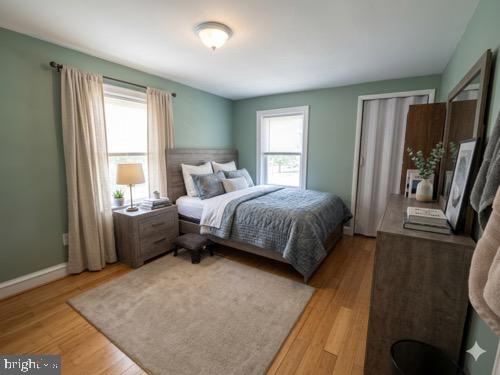 1515 Collings Road Camden, NJ 08104 - Photo 13 of 23 a bedroom with a bed wooden floor and window