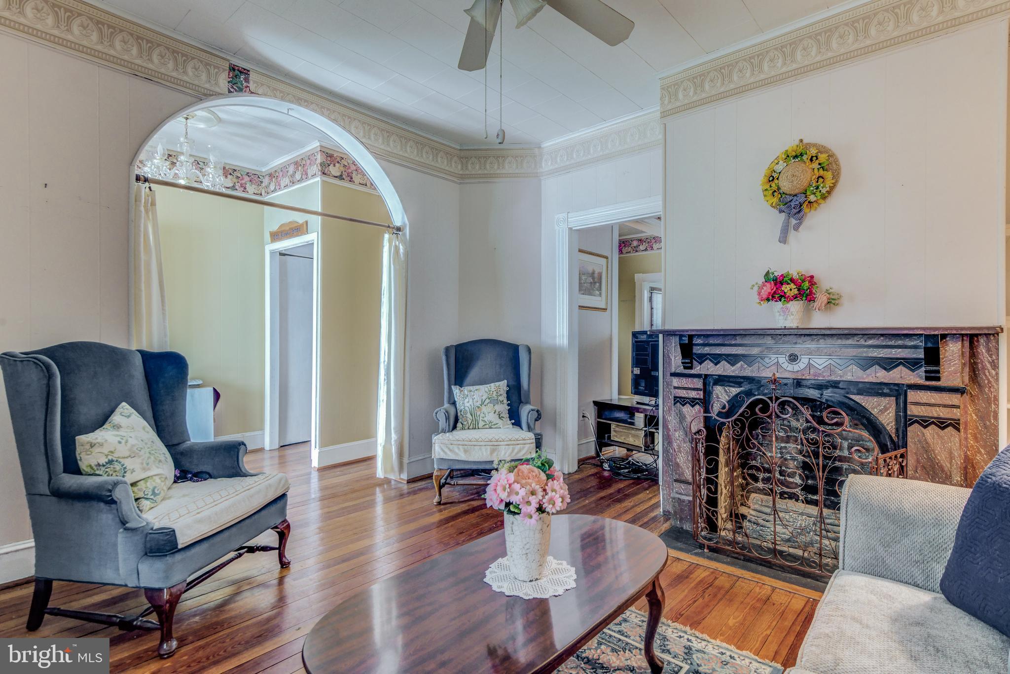 4504 Ridge Avenue Baltimore, MD 21227 - Photo 4 of 31 a living room with furniture and a fireplace