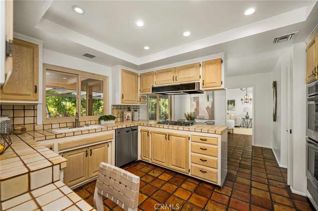 12011 Theta Road North Tustin, CA 92705 - Photo 10 of 49 Newer double ovens, gas stove top, dishwasher & refrigerator in the kitchen