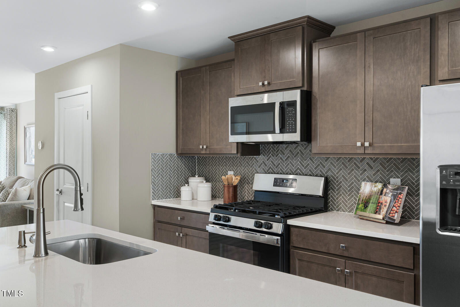 1328 Rollman Farm Road Raleigh, NC 27603 - Photo 7 of 26 a kitchen with stainless steel appliances granite countertop a sink stove and microwave
