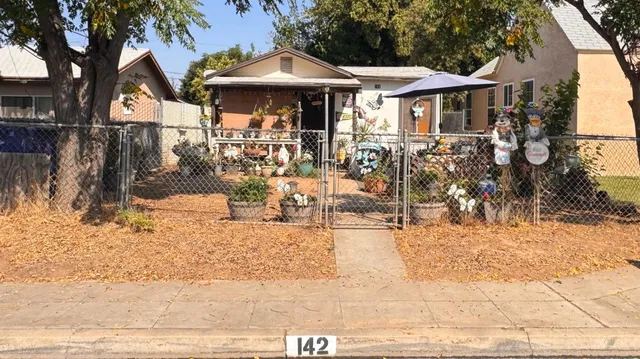 a view of a house with a yard covered in snow