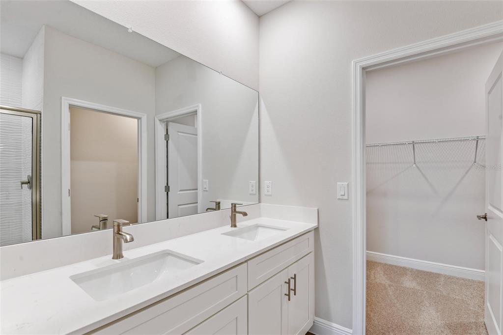 9753 Southwest 62nd Court Ocala, FL 34476 - Photo 16 of 31 a bathroom with a sink and a mirror