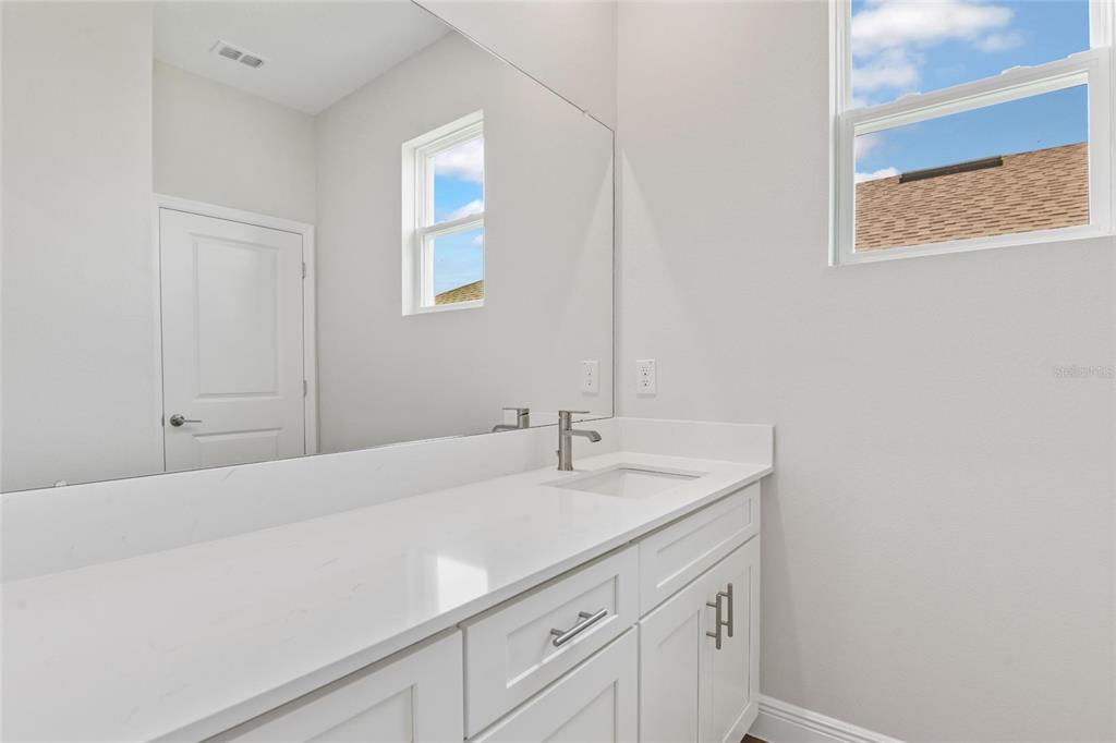 9753 Southwest 62nd Court Ocala, FL 34476 - Photo 22 of 31 a bathroom with a sink and a mirror
