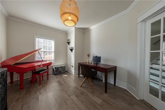 a view of a workspace with furniture and wooden floor