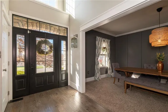 a view of an entryway with wooden floor and windows
