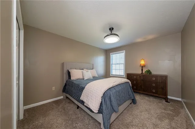 a bedroom with a bed and a lamp