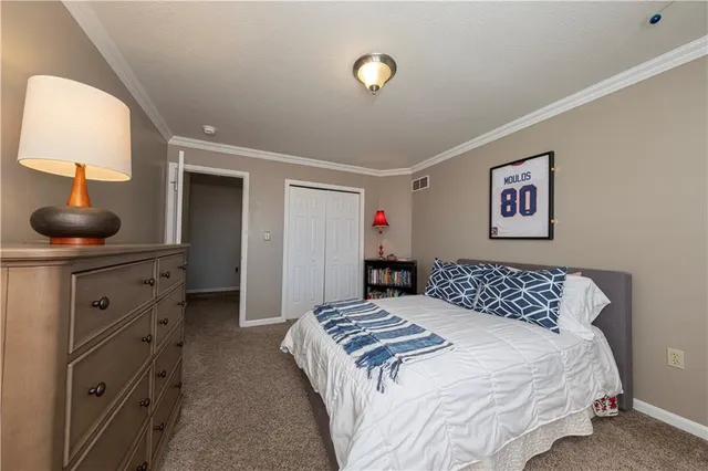 a bedroom with a large bed and a dresser