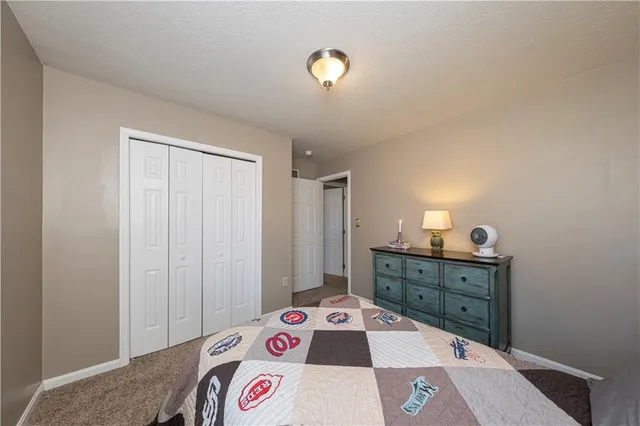 a bed room with a bed and a dresser