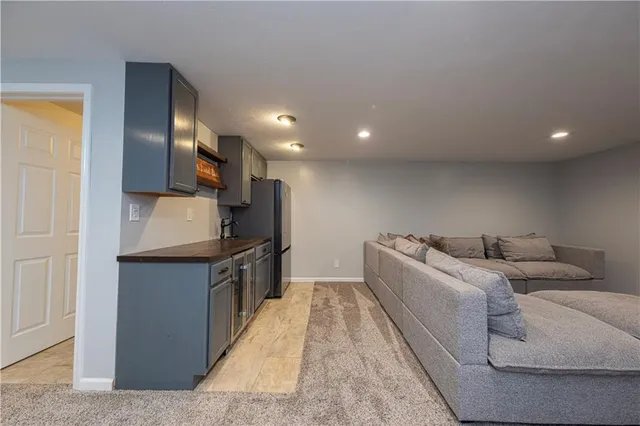 a kitchen with stainless steel appliances kitchen island granite countertop a refrigerator and a sink