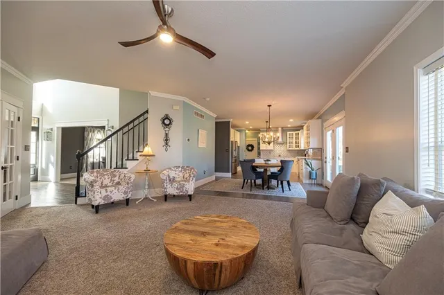 a living room with furniture and a chandelier