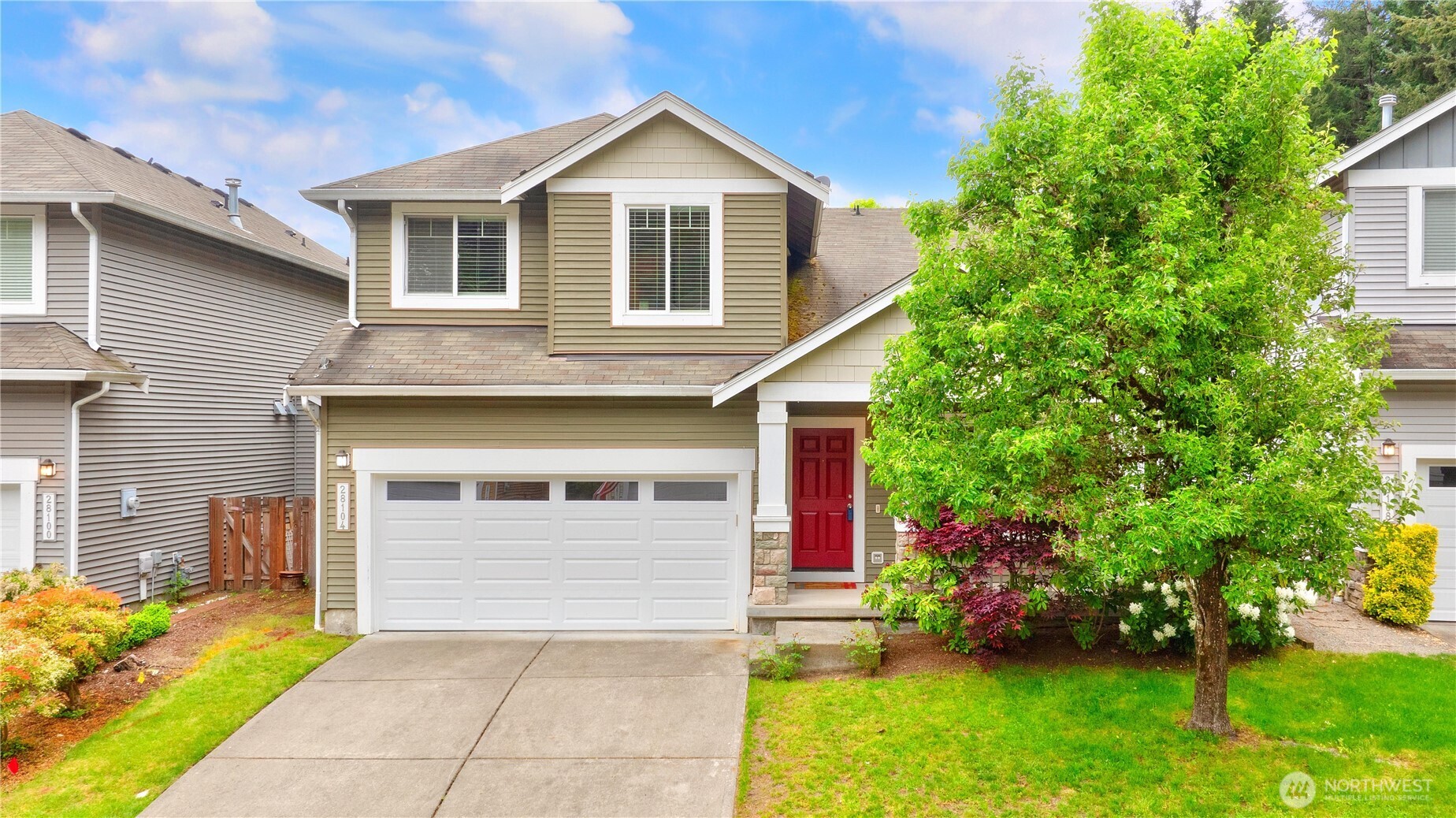 28104 Maple Ridge Way Southeast Maple Valley, WA 98038 - Photo 1 of 26 a front view of a house with a yard and garage
