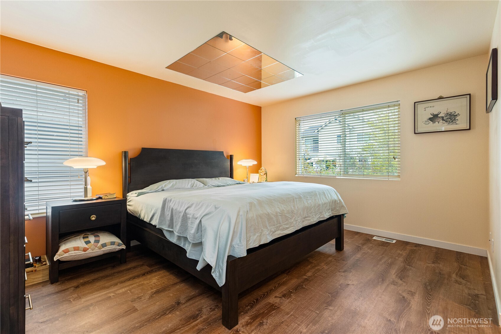 28104 Maple Ridge Way Southeast Maple Valley, WA 98038 - Photo 15 of 26 a bedroom with a bed and wooden floor