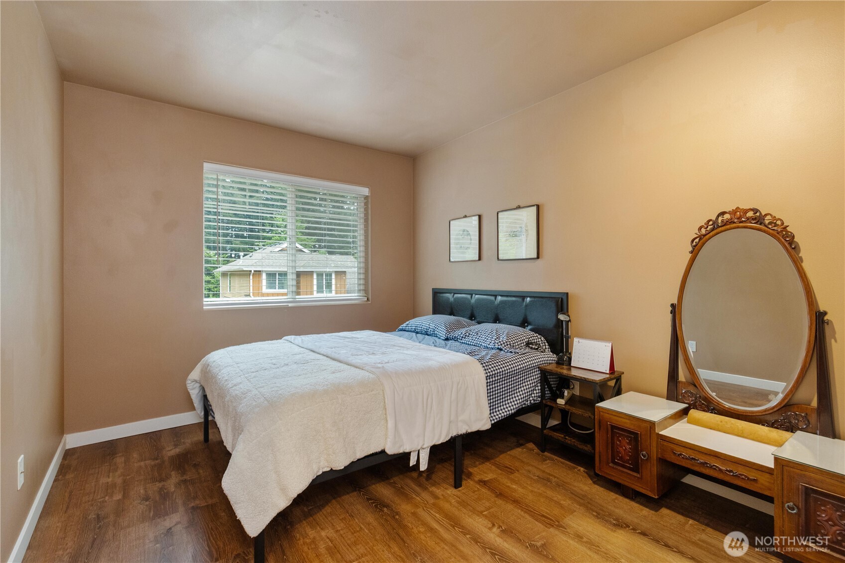 28104 Maple Ridge Way Southeast Maple Valley, WA 98038 - Photo 20 of 26 a bedroom with a bed a mirror and a window