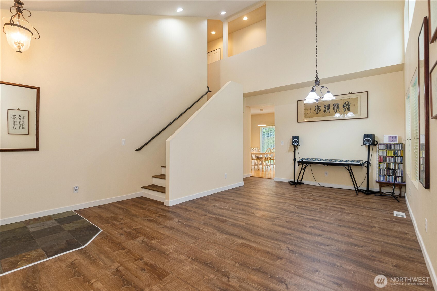 28104 Maple Ridge Way Southeast Maple Valley, WA 98038 - Photo 3 of 26 a view of a room with wooden floor and stairs