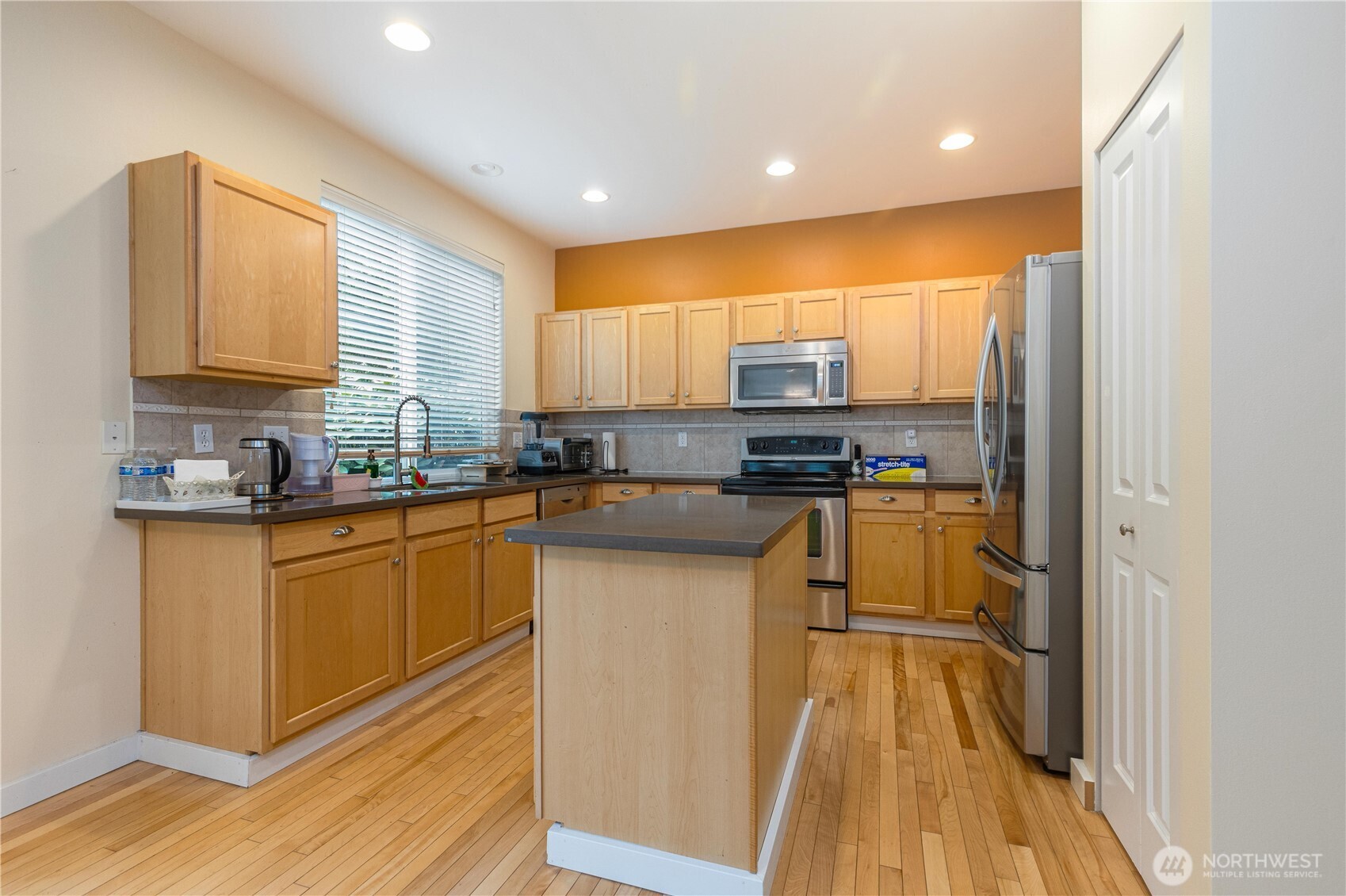 28104 Maple Ridge Way Southeast Maple Valley, WA 98038 - Photo 5 of 26 a kitchen with stainless steel appliances granite countertop a stove a sink and a refrigerator