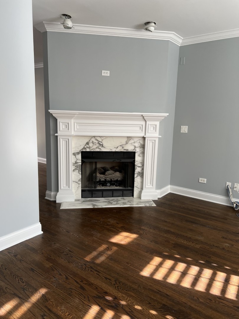 Undisclosed Address Chicago, IL 60614 - Photo 12 of 22 a view of empty room with wooden floor and fireplace