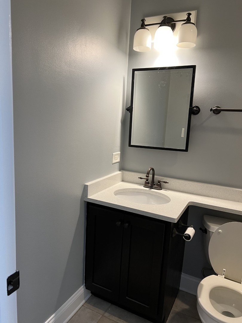 Undisclosed Address Chicago, IL 60614 - Photo 21 of 22 a bathroom with a toilet sink and mirror