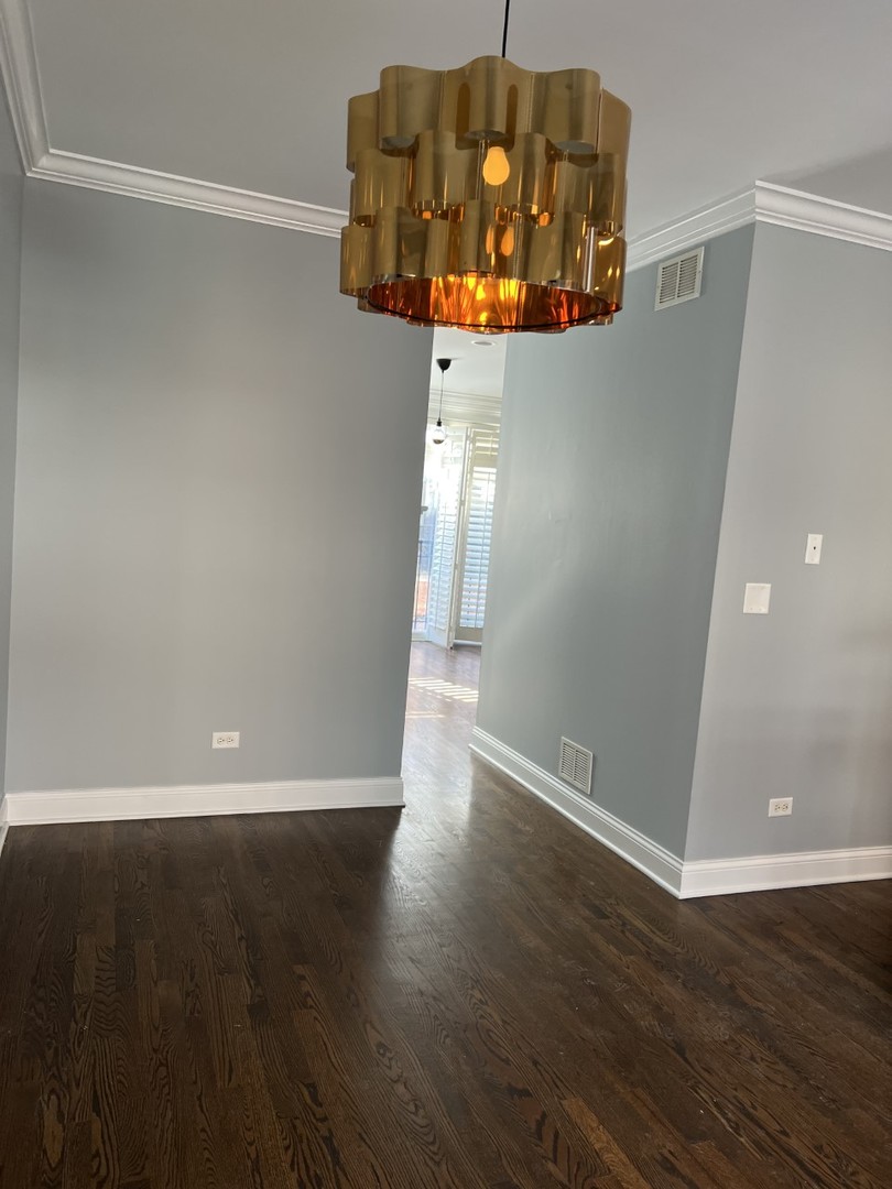 Undisclosed Address Chicago, IL 60614 - Photo 9 of 22 an empty room with wooden floor and windows