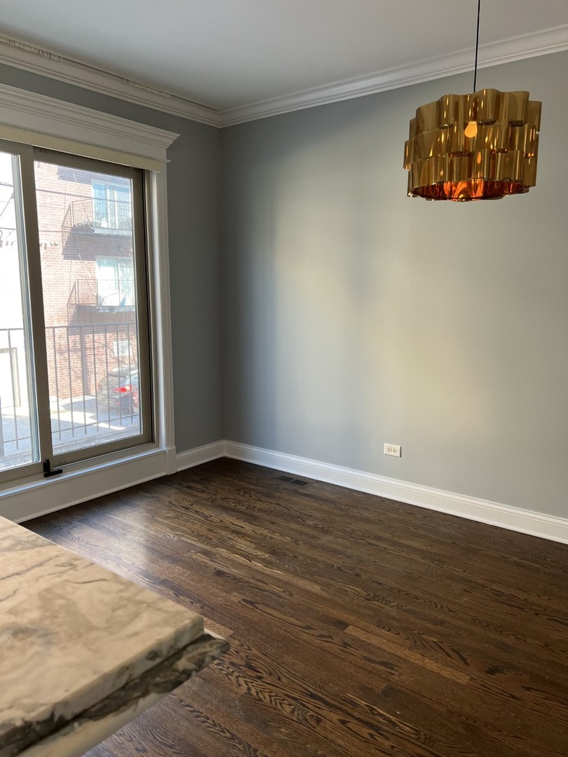 Undisclosed Address Chicago, IL 60614 - Photo 10 of 22 a view of an empty room with a window and wooden floor