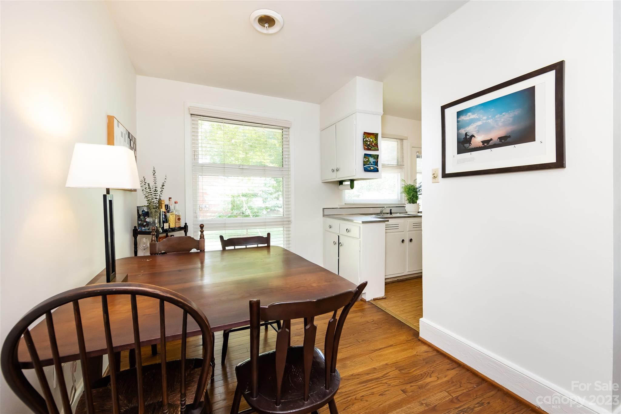 1011 Andover Road Charlotte, NC 28211 - Photo 11 of 29 a kitchen with stainless steel appliances granite countertop a stove a dining table and chairs with wooden floor