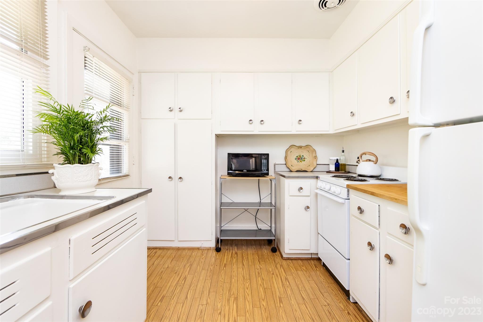 1011 Andover Road Charlotte, NC 28211 - Photo 15 of 29 a kitchen with white cabinets and sink