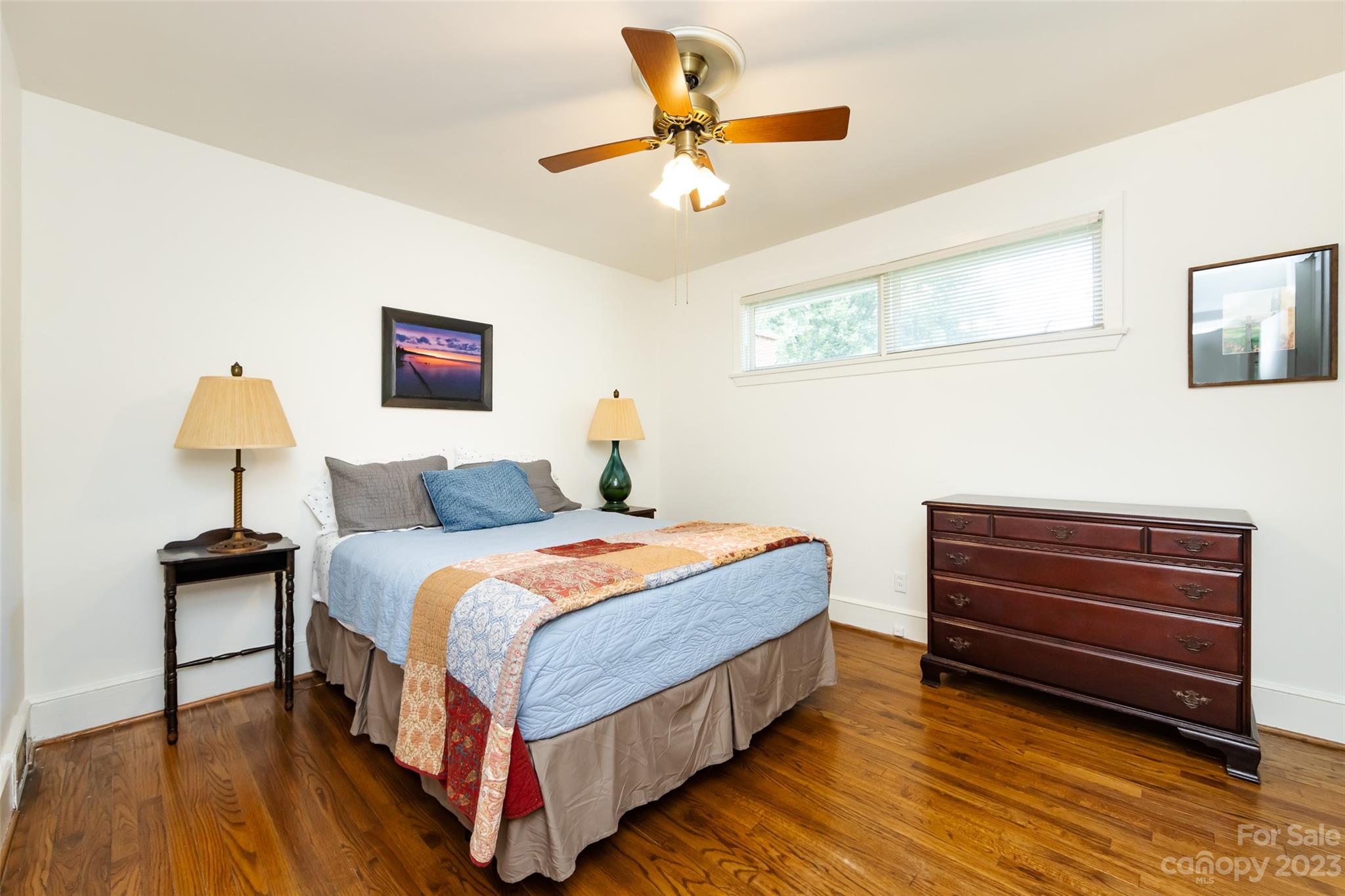 1011 Andover Road Charlotte, NC 28211 - Photo 20 of 29 a bedroom with a bed and a chandelier